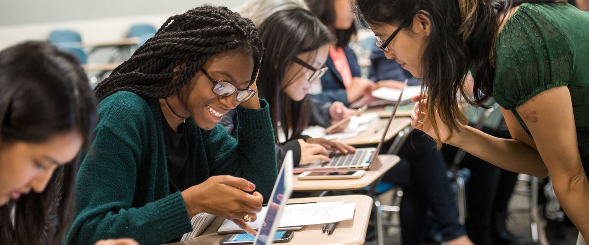Amber Navarre, at right, works with Deanna Clarke-Campbell (CAS'21), left, during Navarre's Chinese course. For a story about Teaching with Technology conference. Photo by Cydney Scott