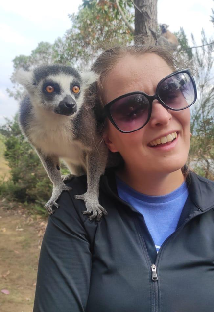 Katie Pederson with a lemur on her shoulder