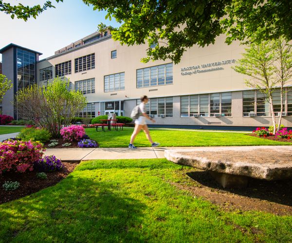 person walking past the College of Communications