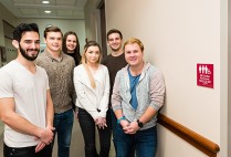 The six Questrom students who got the restrooms’ designation changed are Benji Hadar (Questrom’16) (from left), Alex Paroda (Questrom’16), India Mazzarelli (Questrom’17), Halle Gecawich (Questrom’16), Zach Cracknell (Questrom’16), and Zack Robinson  (Questrom’16). Photo by Dana J. Quigley