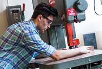 Woodworker Justin Fiaschetti of Fiaschetti Woodworking crafts a desk in his workshop.