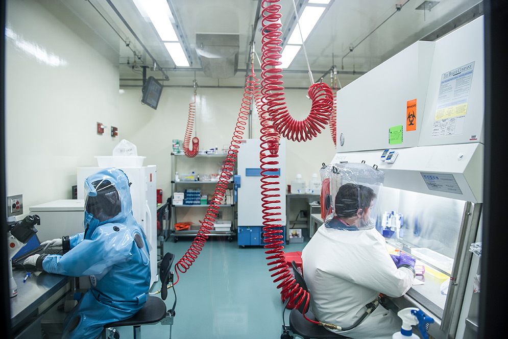 Infectious disease researchers Elke Mühlberger (left) and Adam Hume conduct BSL-4 research at Boston University's National Emerging Infectious Diseases Laboratories (NEIDL).