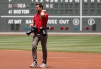 Billie Weiss, the Red Sox manager of photography, on the field wearing multiple cameras