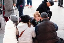 Karen Pita Loor, a School of Law clinical associate professor of law, talks to Central American migrants in Tijuana, Mexico, about the US asylum process, during a recent trip by LAW faculty and students to the border.
