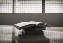 Stack of books on a table in a prison