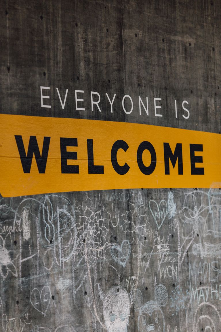Sign on chalk wall that reads Everyone Is Welcome