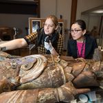 Christina Yu Yu (GRS'04) take a closer look at Bishamoten, the Guardian of the North with Associate Conservator Linsly Boyer at the MFA, where Boyer is working on restoring a collection of 12th century pieces.