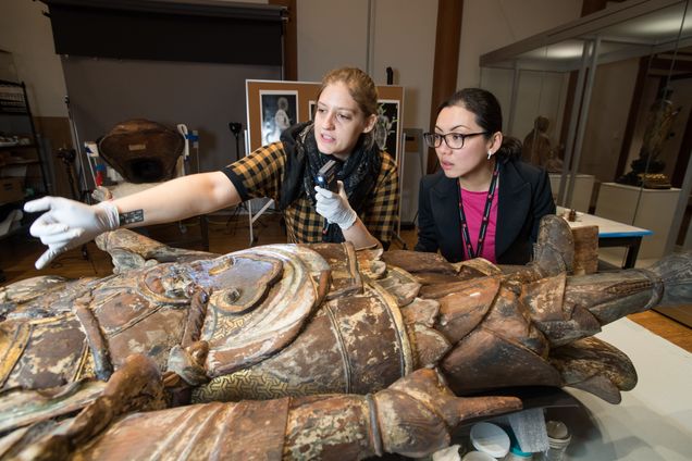 Christina Yu Yu (GRS'04) take a closer look at Bishamoten, the Guardian of the North with Associate Conservator Linsly Boyer at the MFA, where Boyer is working on restoring a collection of 12th century pieces.