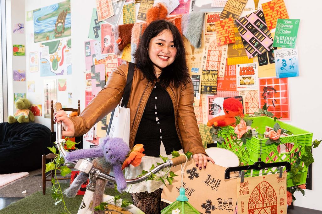 August Ramos (CFA’23) shows off some of the ephemera seen in her senior thesis runway show.