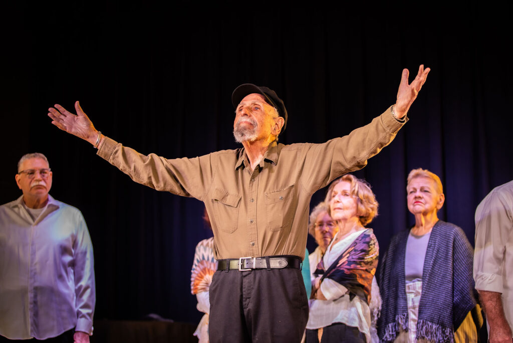Harvey Widell (CFA'57) a former English teacher now actor and director standing on a stage