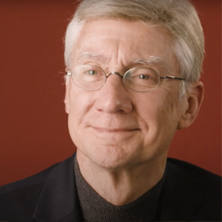 Actor David Garrison pictured against a red backdrop