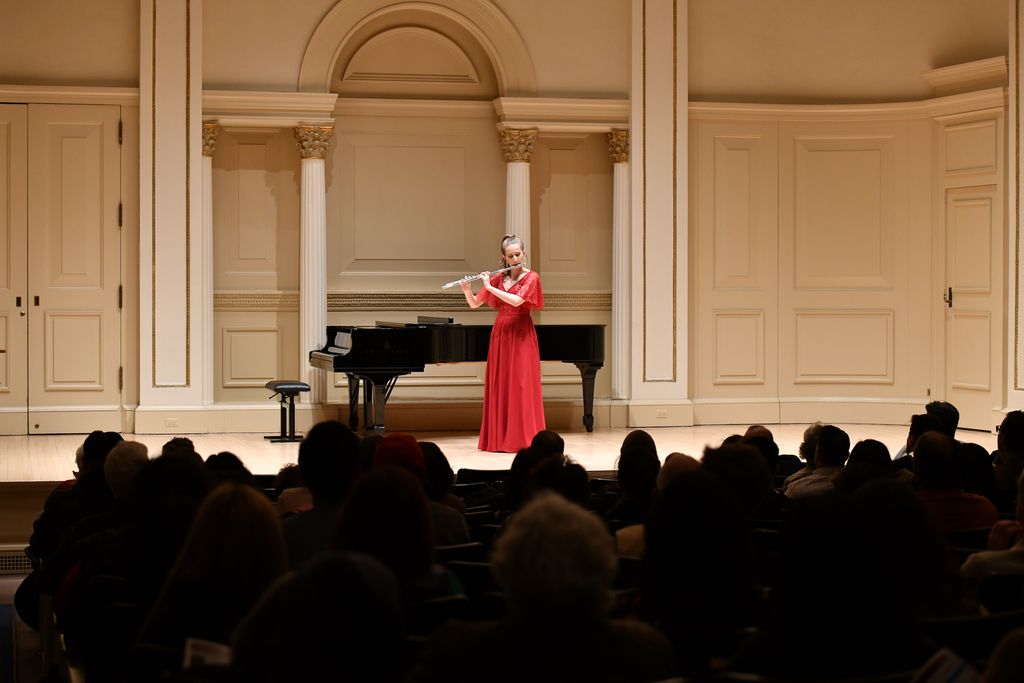 Flutist performing on stage in Weill Recital Hall at Carnegie Hall for Boston University Spotlight Concert