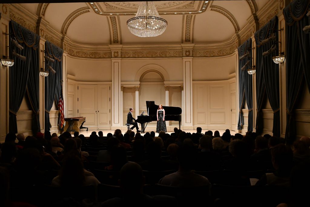 Pianist and singer performing for crowd on stage in Weill Recital Hall at Carnegie Hall for Boston University Spotlight Concert
