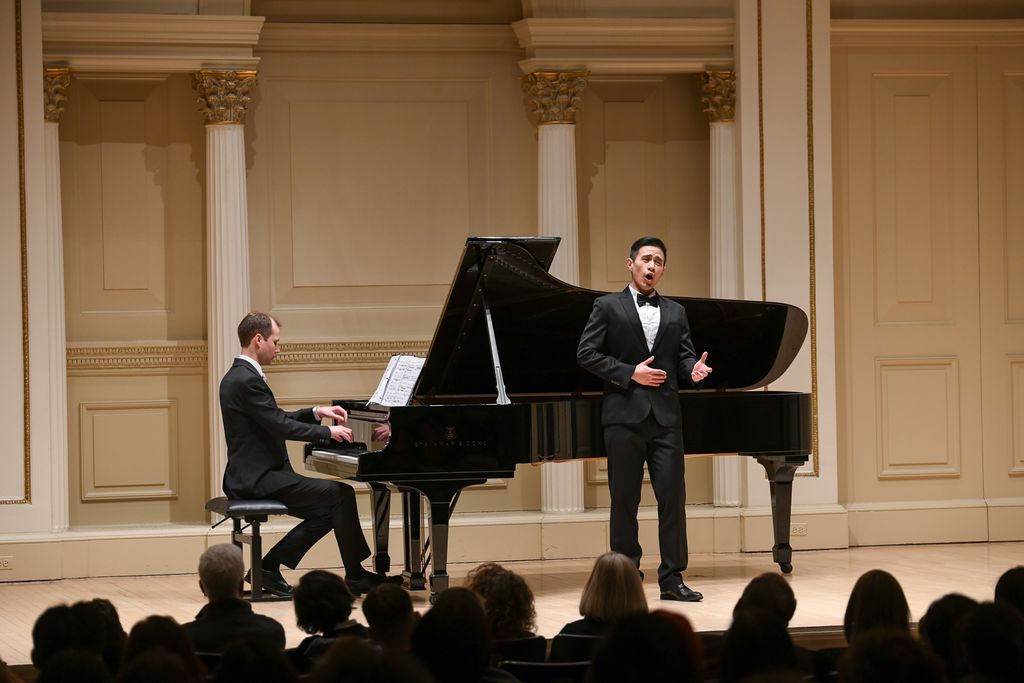 Pianist and singer performing for crowd on stage in Weill Recital Hall at Carnegie Hall for Boston University Spotlight Concert