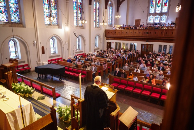 Dean Hill preaching from the pulpit looking out over the congregation