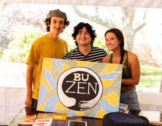 Members of BU Zen pose with their sign