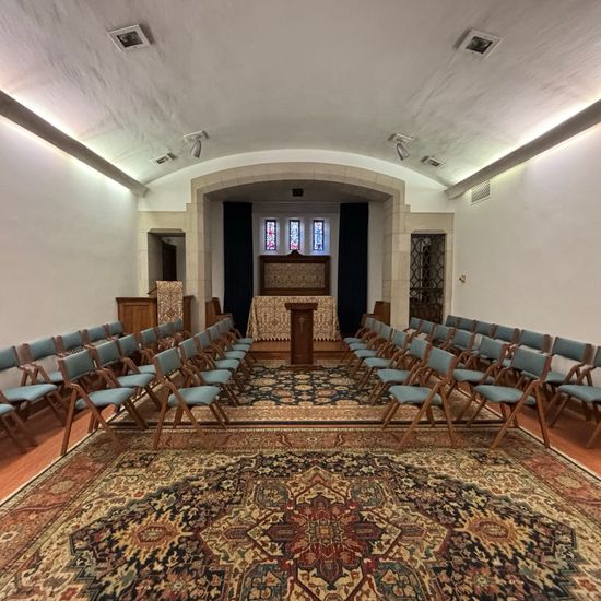 Interior of 罗宾逊教堂 set up with chairs in rows and a pulpit in the center of the stage area