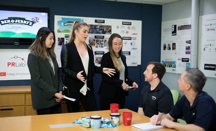Group of PRLab students standing and presenting to clients.