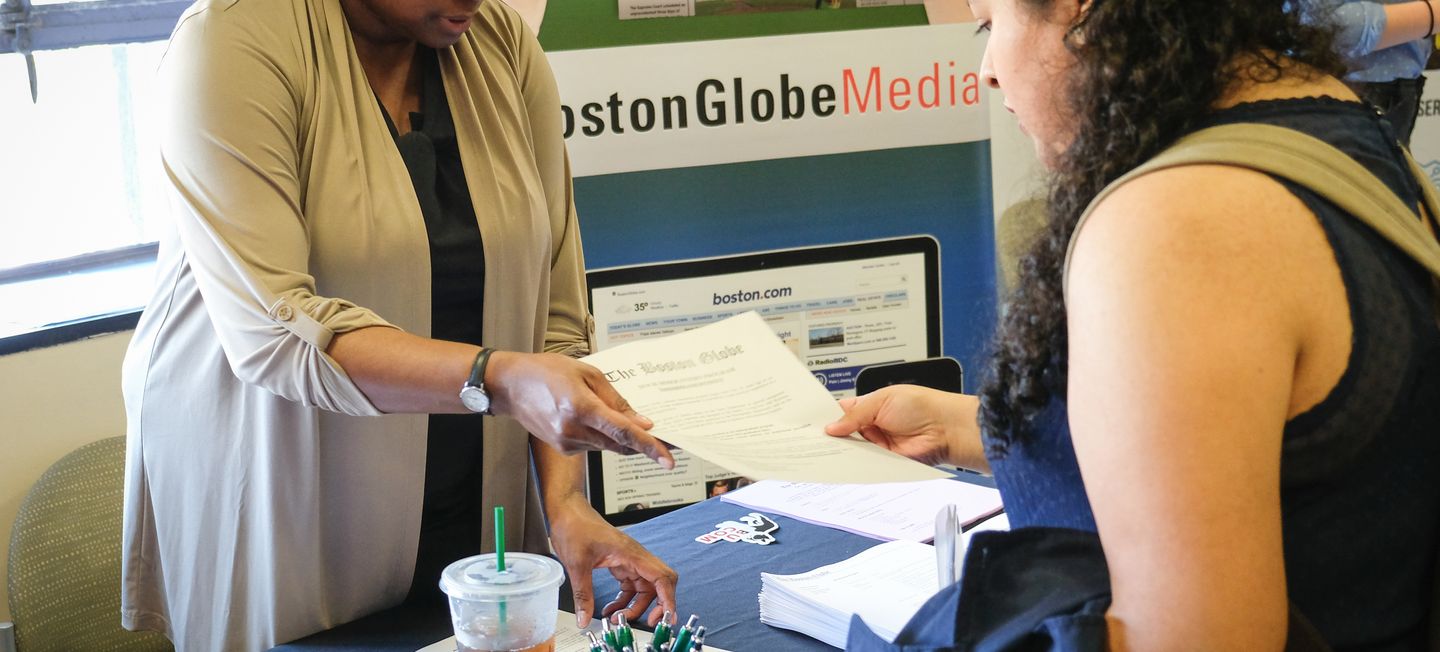 Student chatting with prospective employer at a job fair.