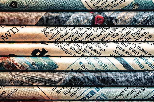 Rolled newspaper pages abstract background