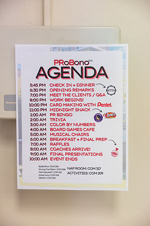 A sign posted on the wall outlining the agenda for PRLab's PRoBono event, which runs from 5:45 p.m. until 10:00 a.m. the following day.