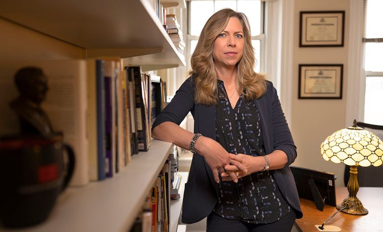 Michelle Amazeen standing next to a bookshelf.
