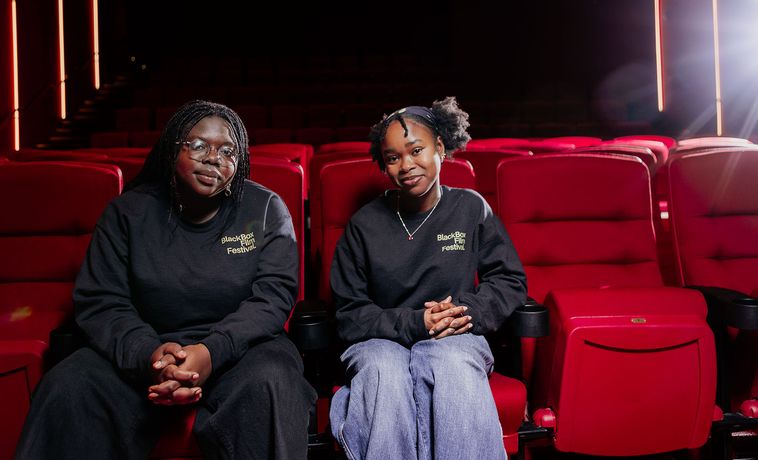 Lynn and Lydia in theatre seats.