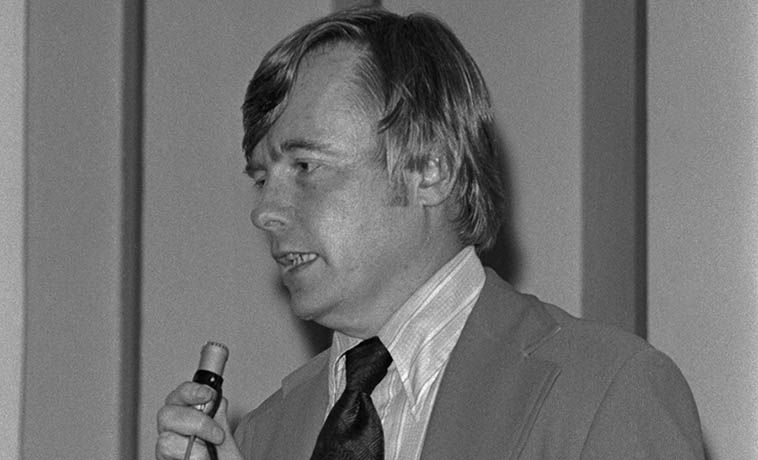 James Brann speaking at a lectern.