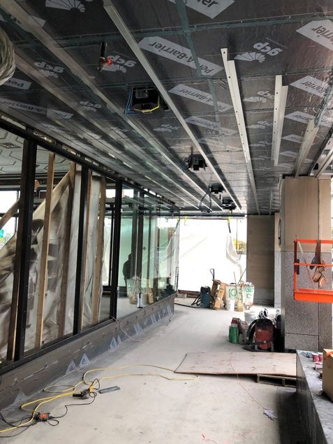 Installation of curtain wall glass in the arcade