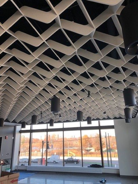 Installation of the “wave” acoustical ceiling in the commons space.