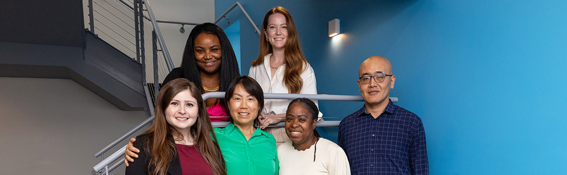 MET Computer Science faculty and staff members pose for a group photo on a staircase
