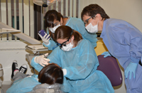 Mita Khanna observes Destinee Ingrao administering local anesthesia while Clinical Assistant Professor in the Department of General Dentistry Dr. Christine Paige supervises Mita Khanna observes Destinee Ingrao administering local anesthesia while Clinical Assistant Professor in the Department of General Dentistry Dr. Christine Paige supervises