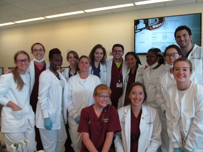 ADEA students pose with participants from the Dental Assisting Program