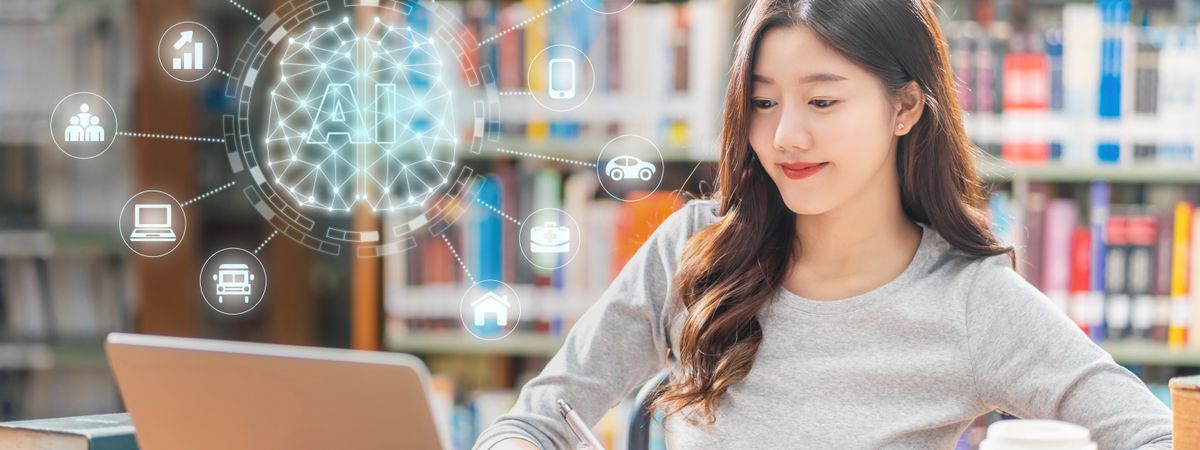 In a library, a young woman is studying with a laptop open in front of her. An AI graphic appears above the computer.