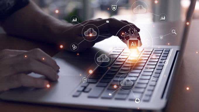 Selective focus at men hand that typing on keyboard to enter command for AI that can access to cloud computing unit that can access to business and customer database to create marketing campaign.