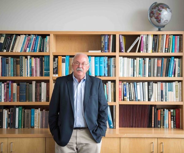 David Bishop standing in front of bookshelf