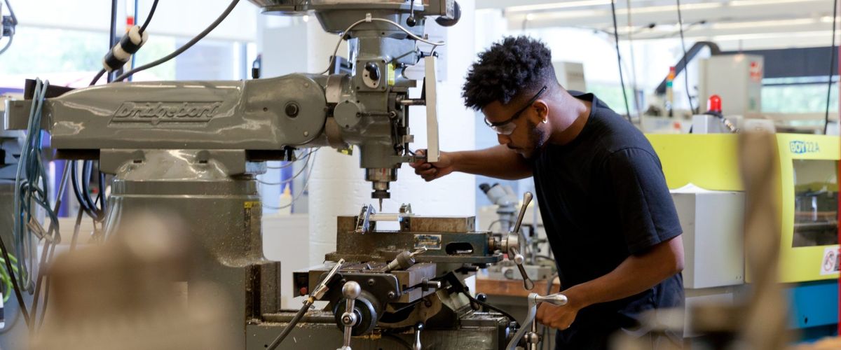 Student operating drill press
