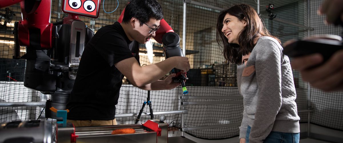 Students working with a robot in the robotics lab at Boston University