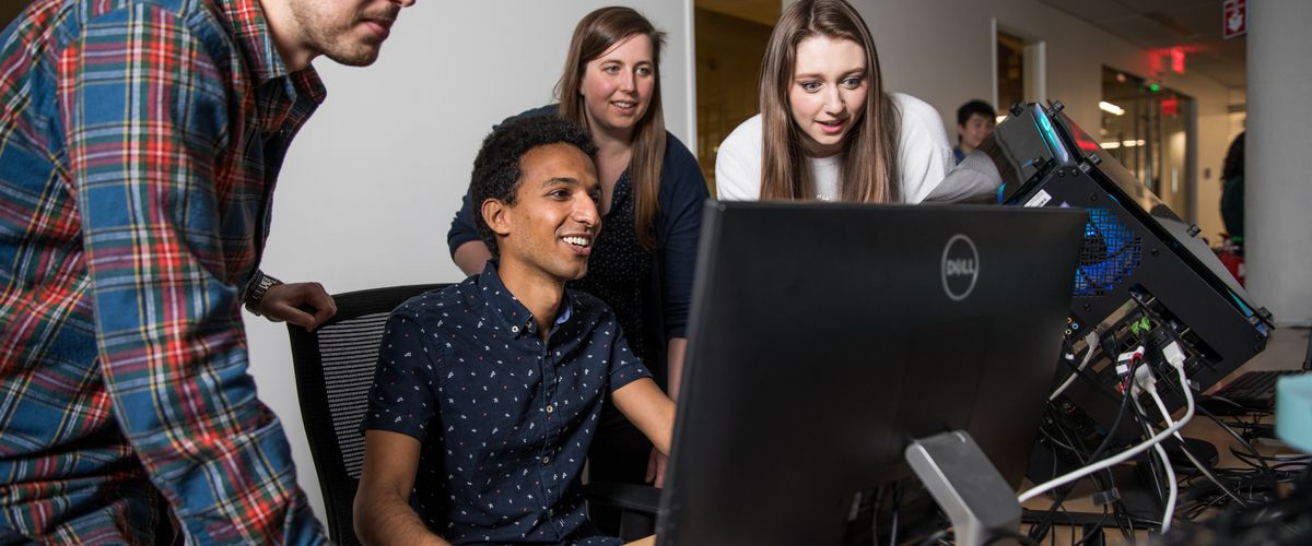 Students huddled around a computer