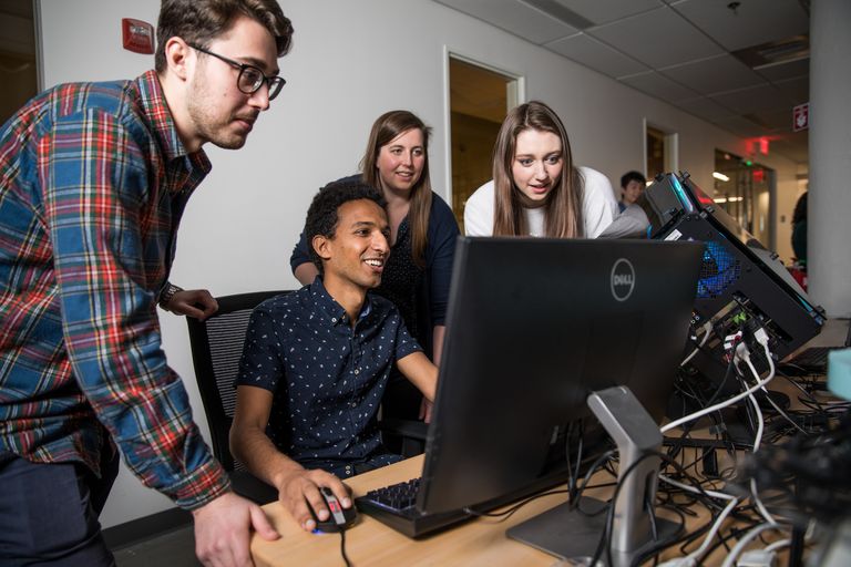 Students huddled around a computer