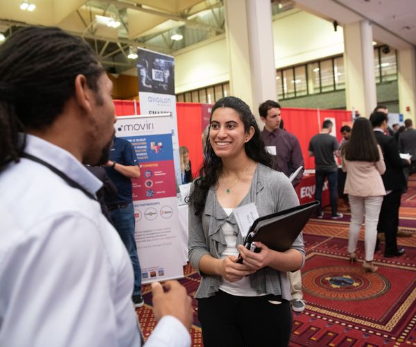 Student networking with industry reps