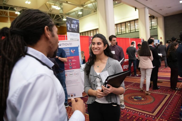 Student networking with industry reps