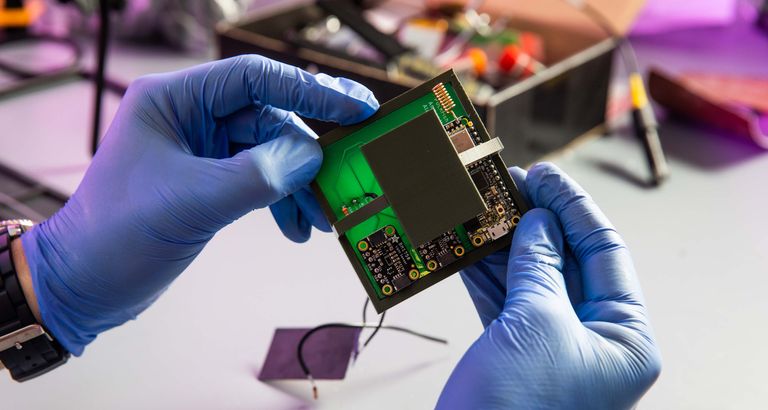 hands holding microchip