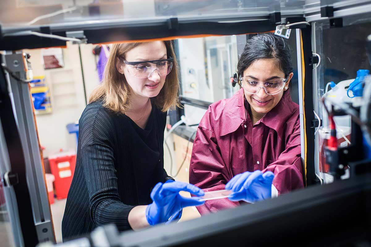 Catherine Klapperich working with a student in her Boston University lab testing point-of-care diagnostics