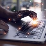 Selective focus at men hand that typing on keyboard to enter command for AI that can access to cloud computing unit that can access to business and customer database to create marketing campaign.