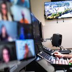 Zachary Dolan is engaged in work, looking at a computer screen with concentration.
