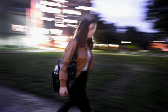 A girl walks in Boston at night