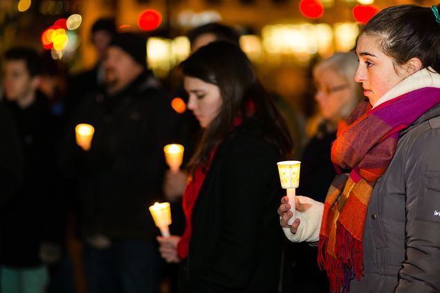 Boston University Against Gun Violence invited members of the BU community to gather on Marsh Plaza for the third annual Vigil for Victims of Gun Violence, one of many happening across the country in solidarity with the Newtown Foundation. Event organizer Lindsay Fuori listens as another speaker provides the closing remarks.  Photo by Dana J. Quigley 