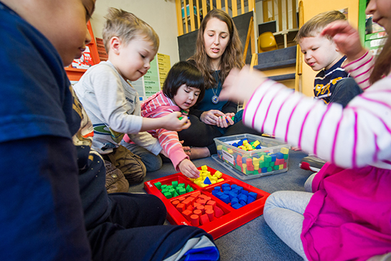 Becky McGhee (SED’12, SED’16), BU Children’s Center lead teacher, with a group of three year olds. Photo by Cydney Scott