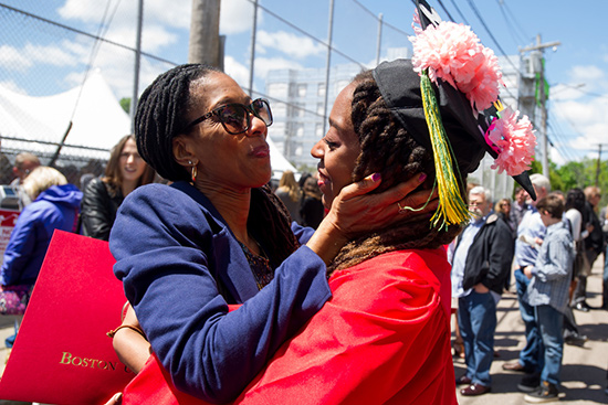 BU graduate Avion Cummings hugs her mother at Boston University's 143rd Commencement Ceremony